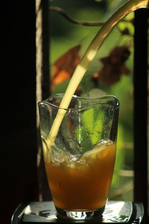 Free Iced drink being poured into a glass, perfect for a hot day. Stock Photo