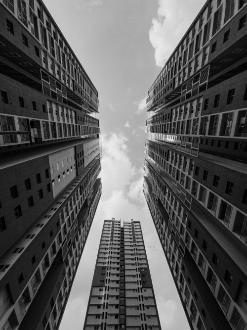 Free Stunning upward view of skyscrapers converging towards the sky, captured in black and white. Stock Photo