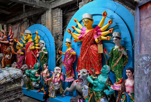 Free Vibrant Durga idols in a Kumartuli workshop showcasing traditional craftsmanship for Durga Puja. Stock Photo