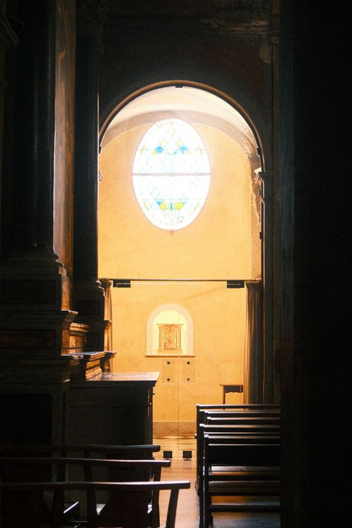 Free A serene and sunlit church interior in Nice, showcasing stained glass and architectural beauty. Stock Photo