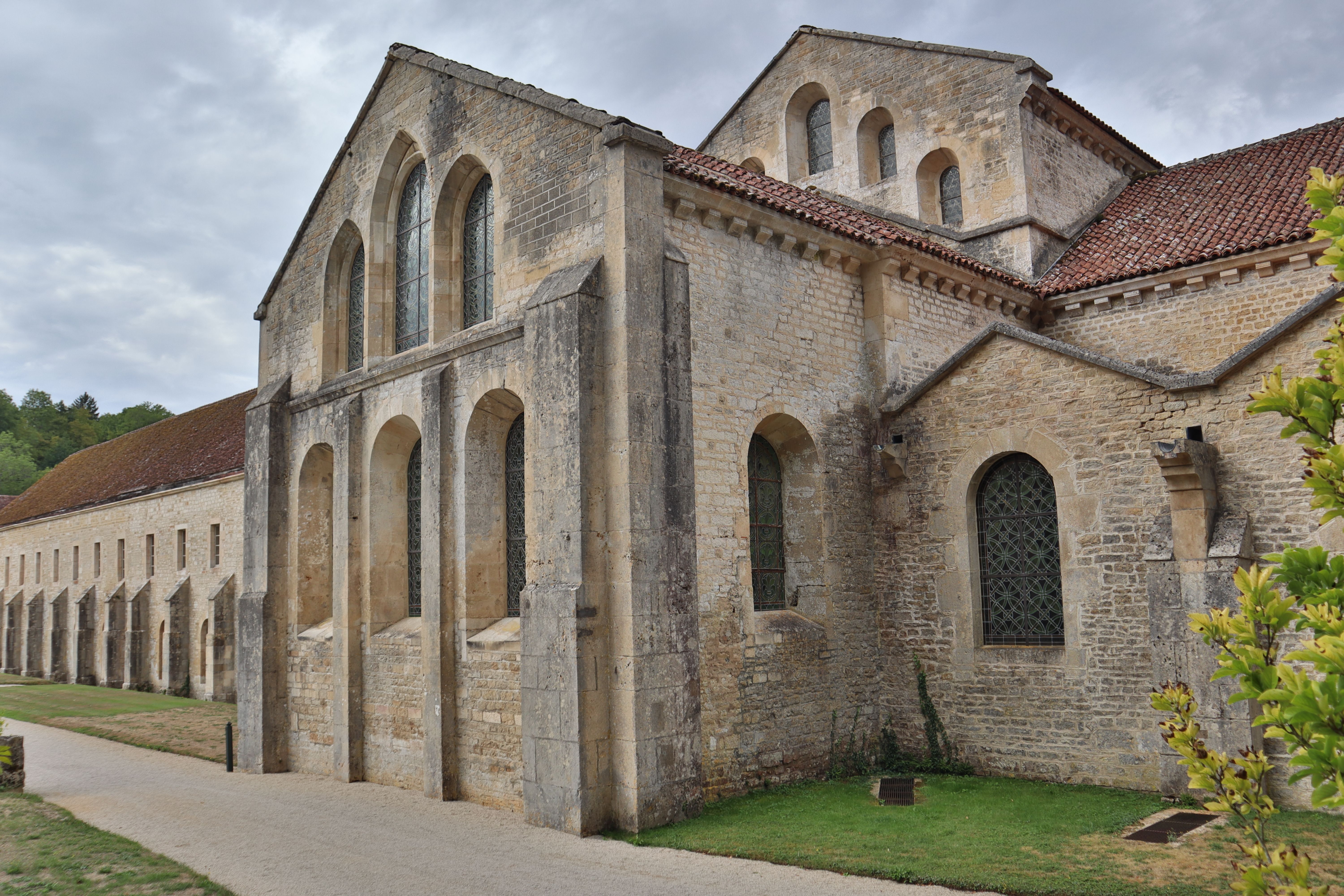 Exterior of a historic stone abbey in Montbard, showcasing French architecture.