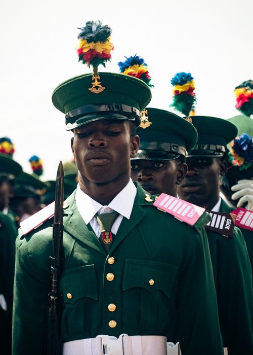 Free Close-up of soldiers in green uniforms with colorful plumes during a formal military parade. Stock Photo