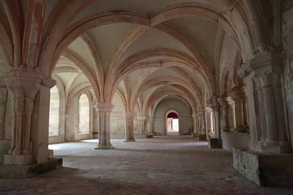 Explore the gothic architecture and grand arches of Montbard Abbey in Bourgogne, France.