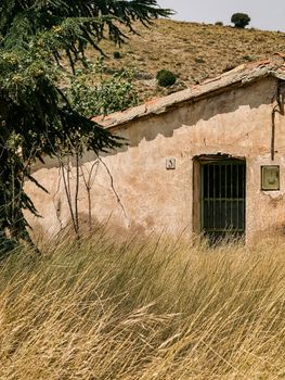 A picturesque rustic house in a rural field in Aragon, Spain, captured during a sunny day.
