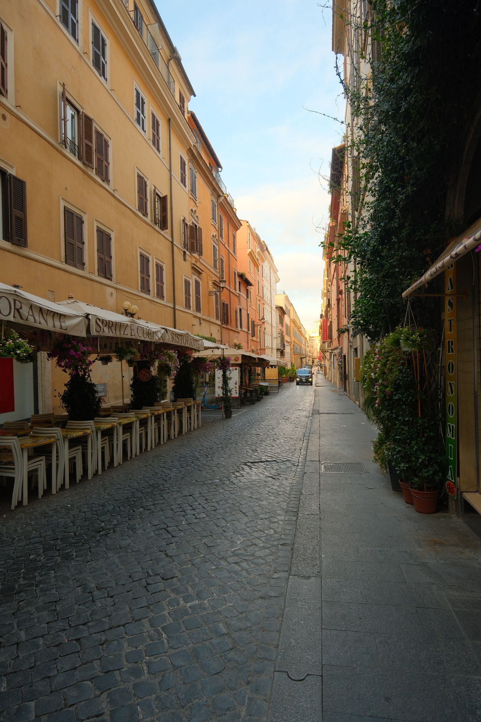 A cobblestone street in Rome with historic buildings
