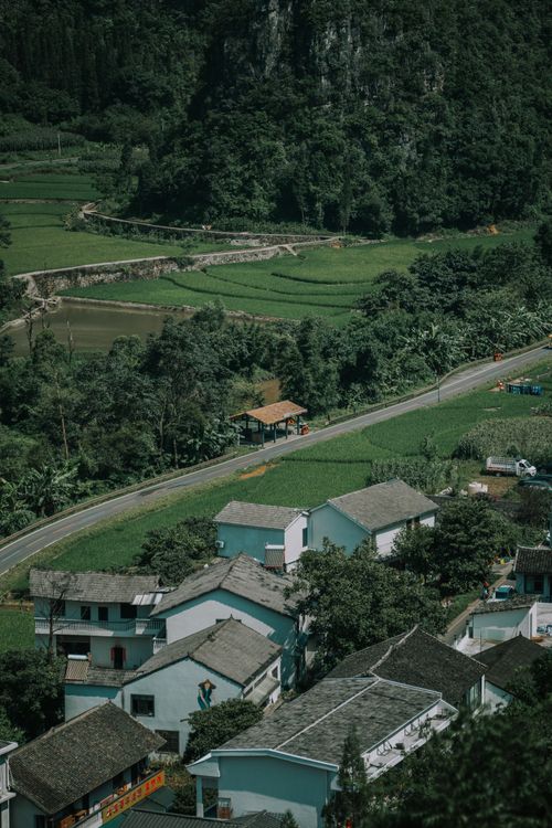 Free Picturesque rural village nestled in lush greenery in Guizhou, China, capturing nature's tranquility. Stock Photo