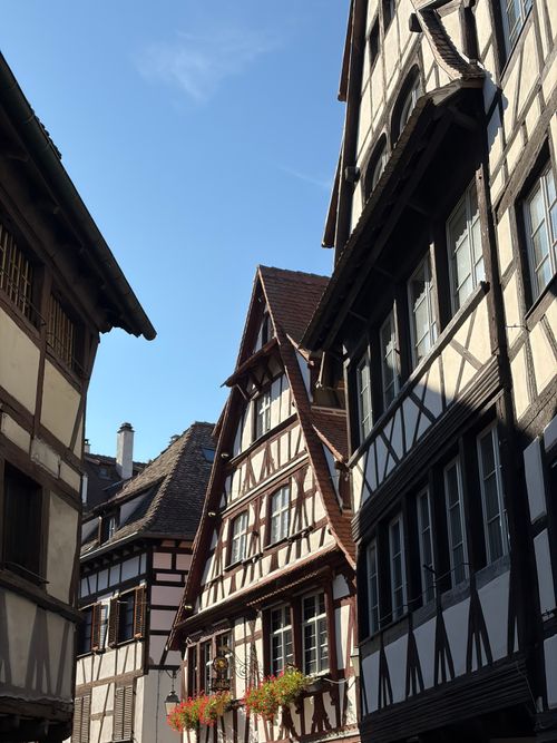 Free Charming timber-framed buildings under a clear blue sky in Strasbourg, France's Petite France district. Stock Photo