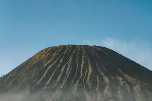 A breathtaking view of Mount Bromo's unique landscape under clear blue skies.