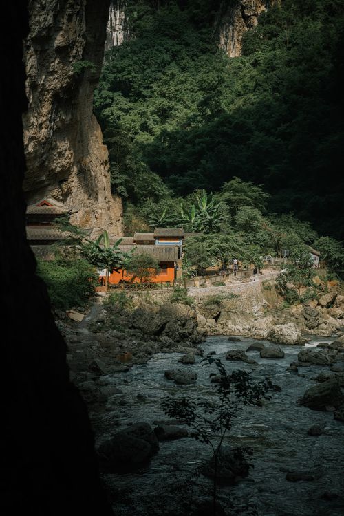 Free Explore a serene riverside village nestled in the lush landscapes of Guizhou, China. Stock Photo
