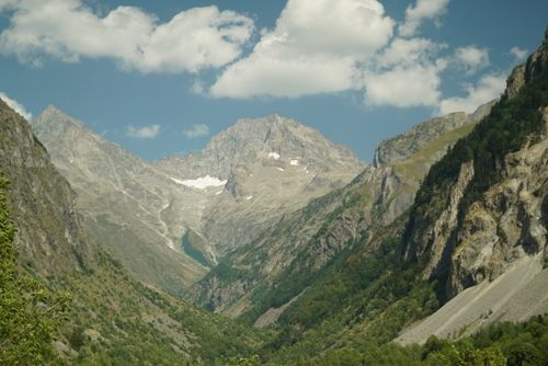 Free Breathtaking view of the Alps during summer with lush greenery and a majestic mountain peak under a blue sky. Stock Photo