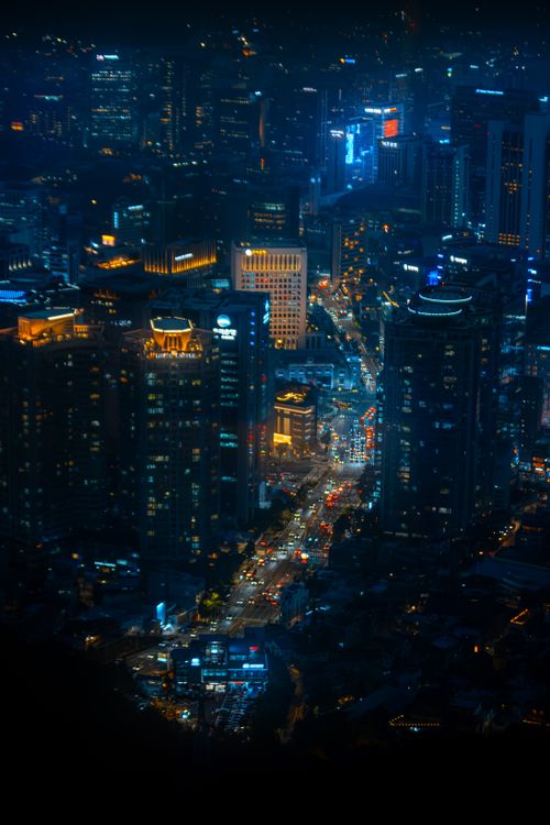 Free A stunning night view of Seoul's bustling cityscape with illuminated skyscrapers and busy streets. Stock Photo
