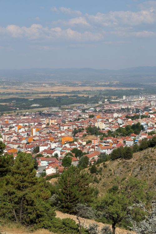 Free Aerial view of a colorful town set against a mountainous backdrop, captured on a sunny day. Stock Photo