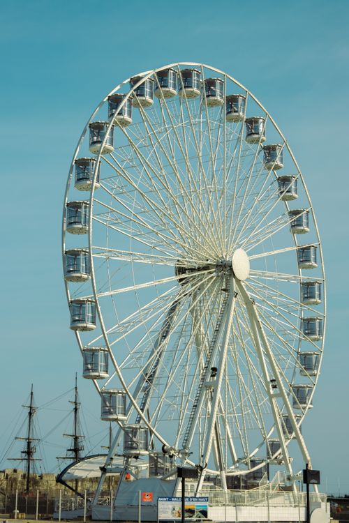 Free A stunning Ferris wheel in Saint-Malo, Brittany, France against a blue sky. Perfect for travel themes. Stock Photo