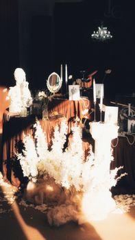 A beautifully arranged vintage table setting with decorative details and floral centerpieces in warm light.