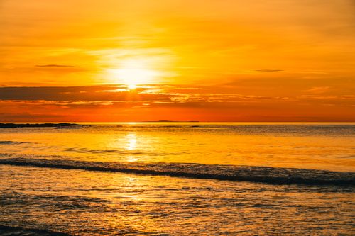Free A breathtaking view of a golden sunset over the ocean waves in Haiphong, Vietnam. Stock Photo