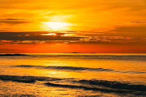 Free Captivating sunset view over the sea at Haiphong, Vietnam, with vibrant orange hues reflecting on the waves. Stock Photo