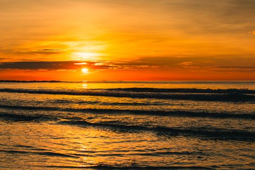 Free Stunning sunrise over Haiphong beach, capturing vivid orange and golden tones. Stock Photo