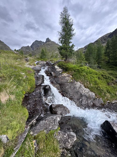 Free Captivating view of a waterfall cascading through rugged alpine terrain in Tyrol, Austria. Stock Photo