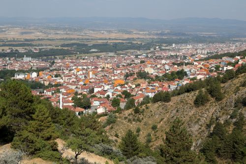 Free Aerial view of a colorful city nestled among hills showcasing vibrant architecture and greenery. Stock Photo