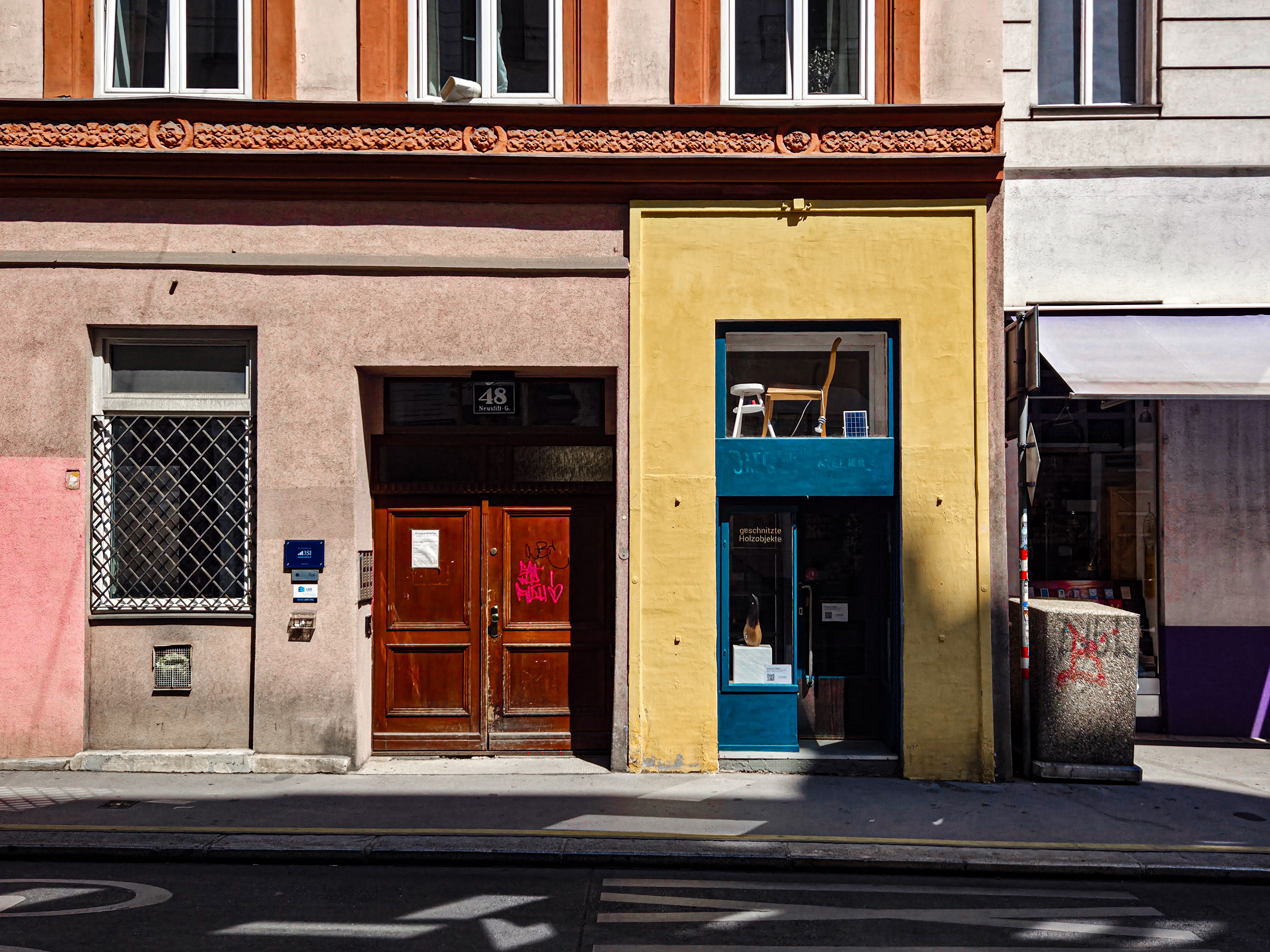 Vibrant urban scene showcasing colorful buildings on a street in Vienna, Austria.