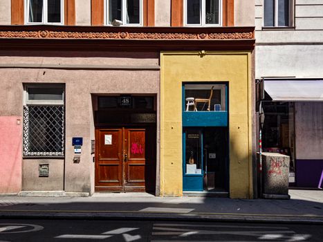 Vibrant urban scene showcasing colorful buildings on a street in Vienna, Austria.