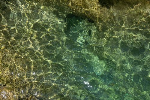 Free Vivid capture of sunlight reflecting on the clear waters of Sapadere Canyon in Antalya, highlighting natural beauty. Stock Photo