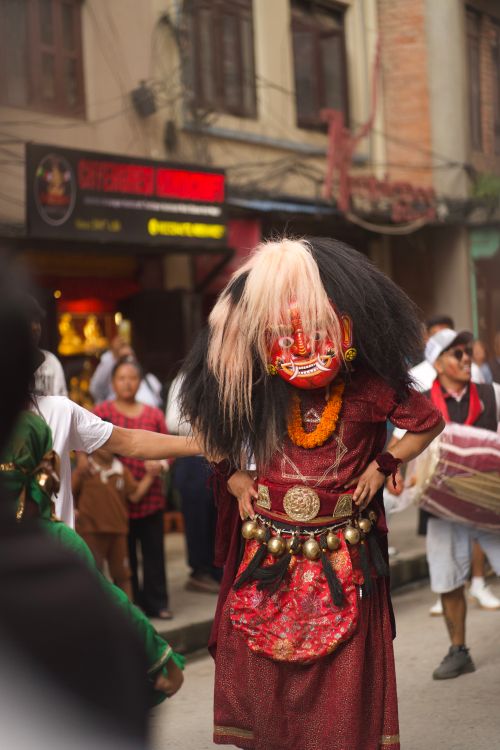 Free A vibrant cultural dancer in traditional attire during a street festival, showcasing local heritage. Stock Photo