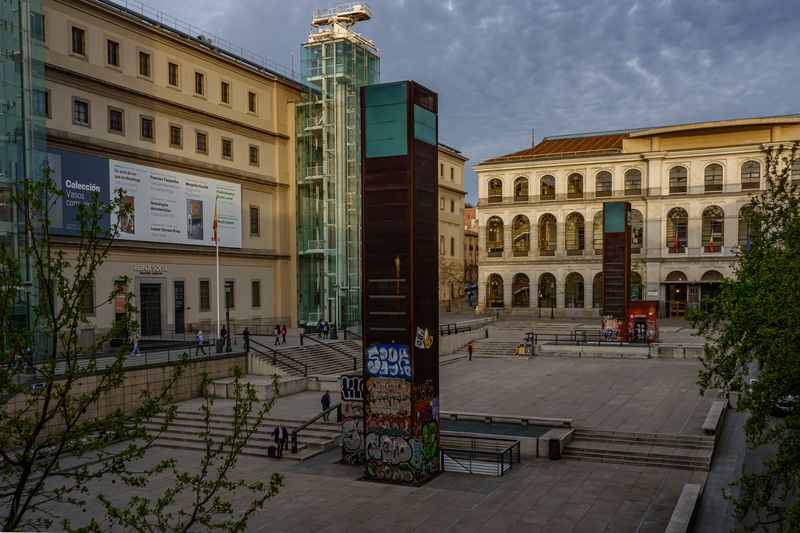 Reina Sofia Museum entrance plaza with glass lift tower in Madrid