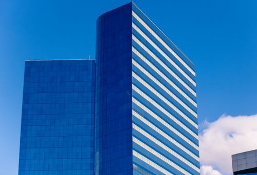 Free Contemporary glass skyscraper against a blue sky in São Paulo, Brazil. Stock Photo