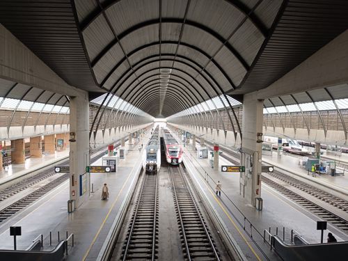 Free A modern railway station in Sevilla featuring trains and geometric architecture. Stock Photo