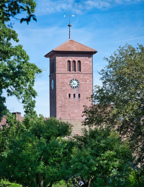 Free Scenic view of the historic clock tower surrounded by lush trees in Schömberg, Germany. Stock Photo