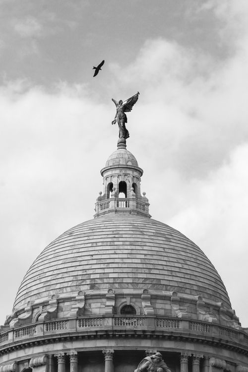 Free Black and white photo of the Victoria Memorial dome topped with an angel statue in Kolkata, India. Stock Photo