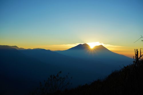 Free Breathtaking sunrise over misty volcano landscape in Sololá, Guatemala. Majestic and serene view. Stock Photo