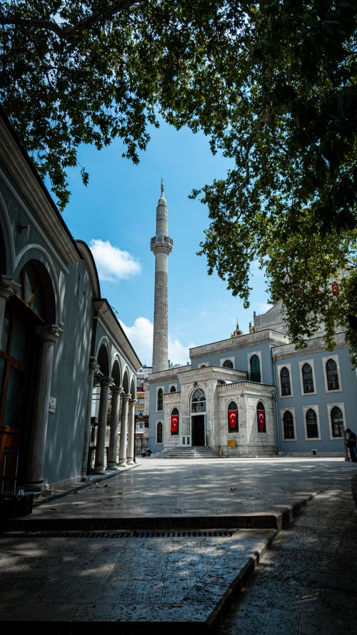 Free Beautiful view of Nuruosmaniye Mosque's courtyard in İstanbul, showcasing Ottoman architecture under blue skies. Stock Photo