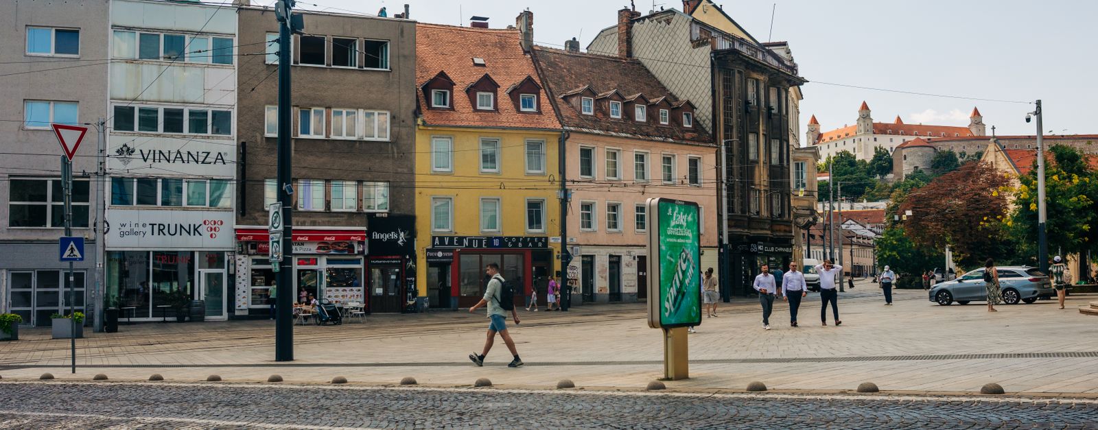 A vibrant day in Bratislava city center, showcasing historic architecture and street life.
