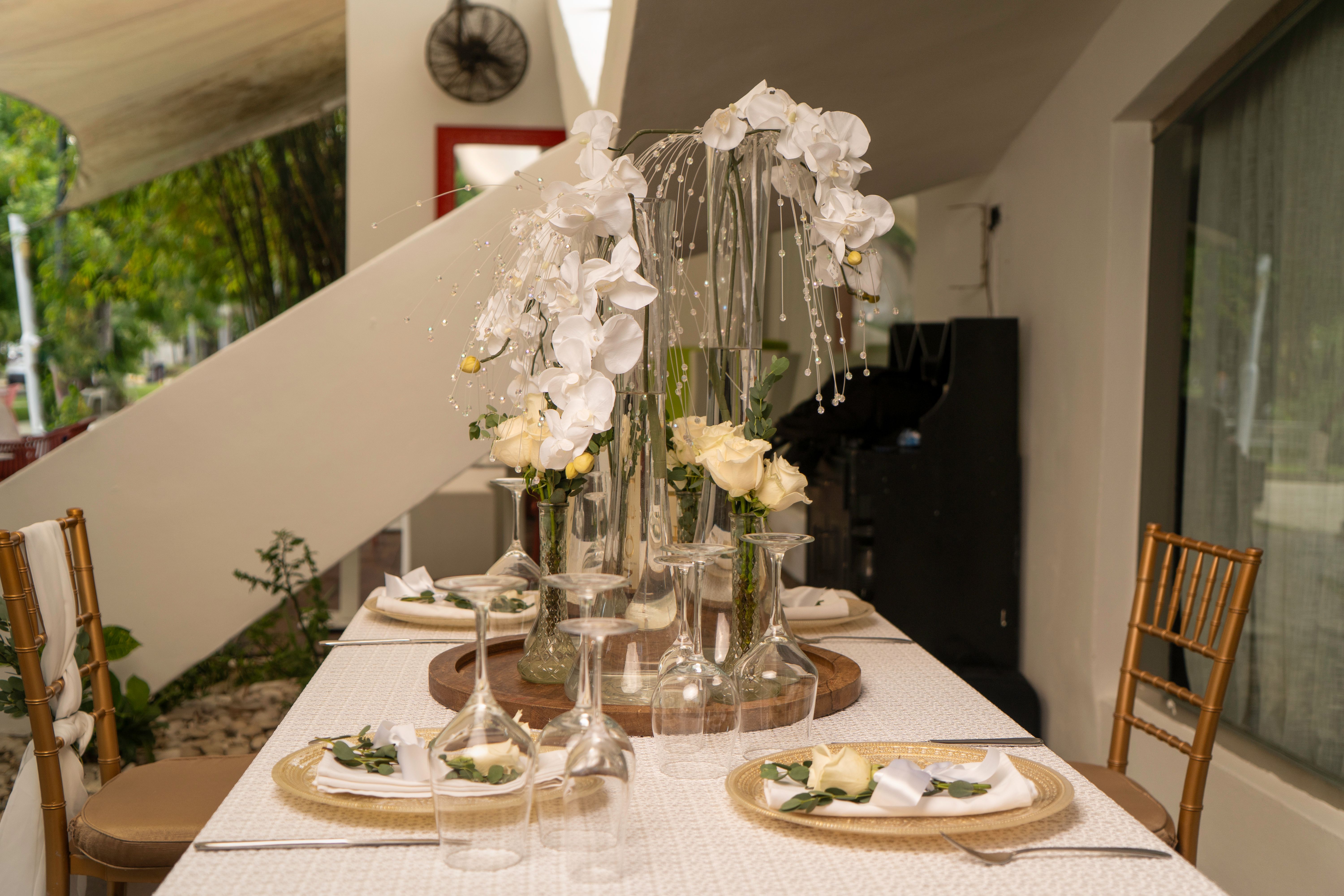 Chic table arrangement featuring white flowers in tall vases, perfect for weddings or elegant dining.