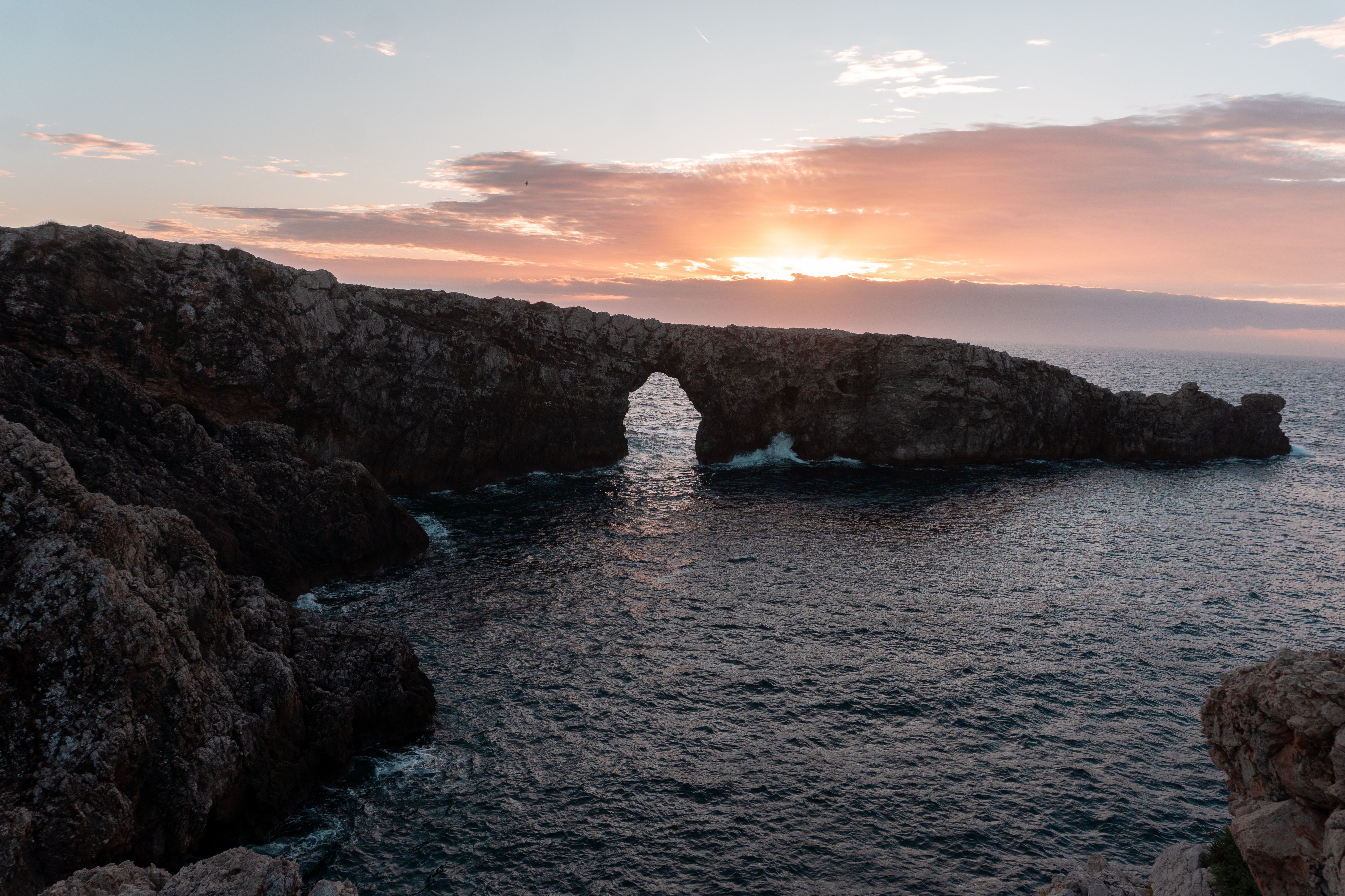 Scenic view of Pont d'en Gil at sunset in Ciutadella, Balearic Islands, capturing coastal beauty.