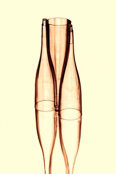 Artistic abstract photo of transparent glass bottles showcasing creative stacking and symmetry in a minimalist style.