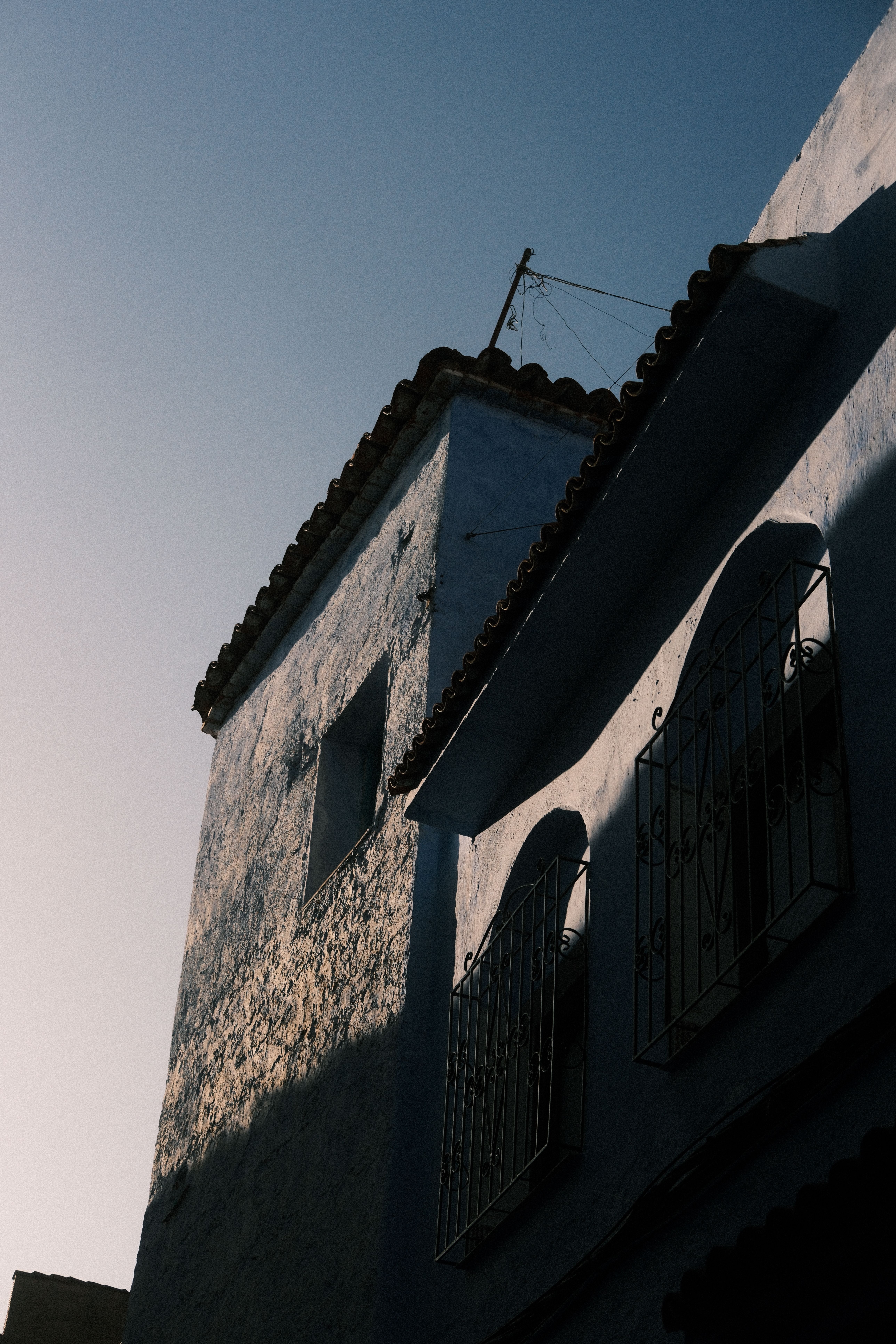 Charming blue facades in the historic streets of Chefchaouen, Morocco, at sunset.