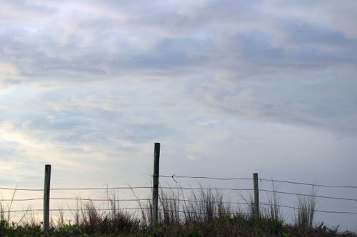Free Tranquil view of a fence against a cloudy sky in Guaratuba, Brazil. Stock Photo
