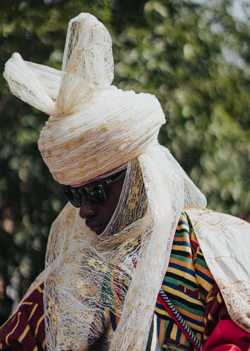 Free Man wearing traditional African attire and turban in outdoor setting. Stock Photo