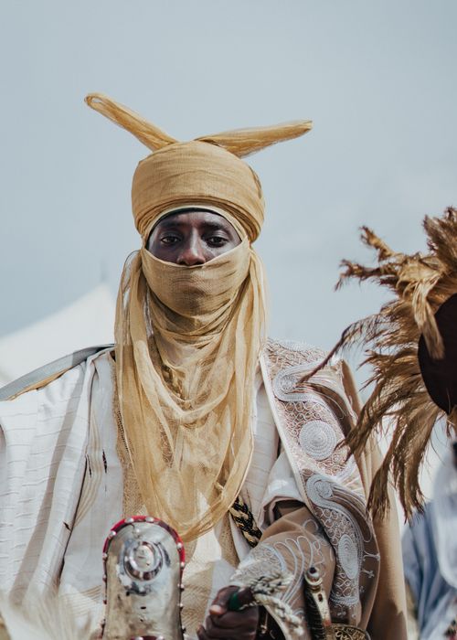 Free African man in traditional attire on a horse, showcasing cultural heritage. Stock Photo