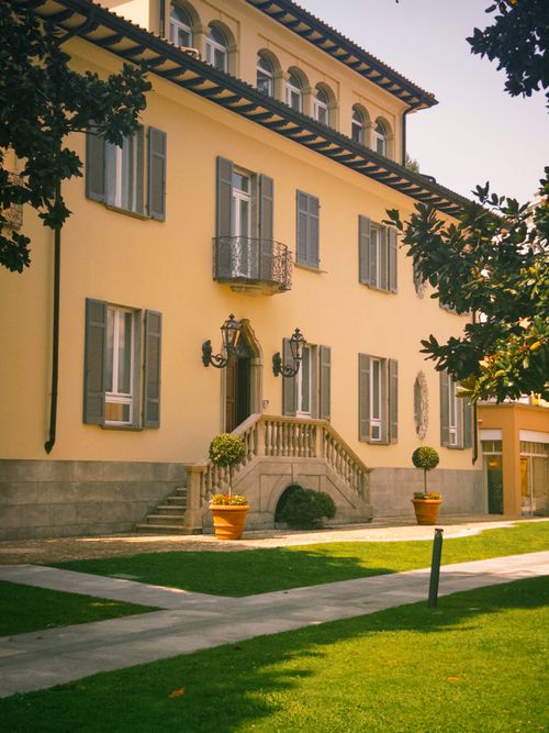 Free Charming European villa with classic architecture and lush green lawn on a sunny day. Stock Photo