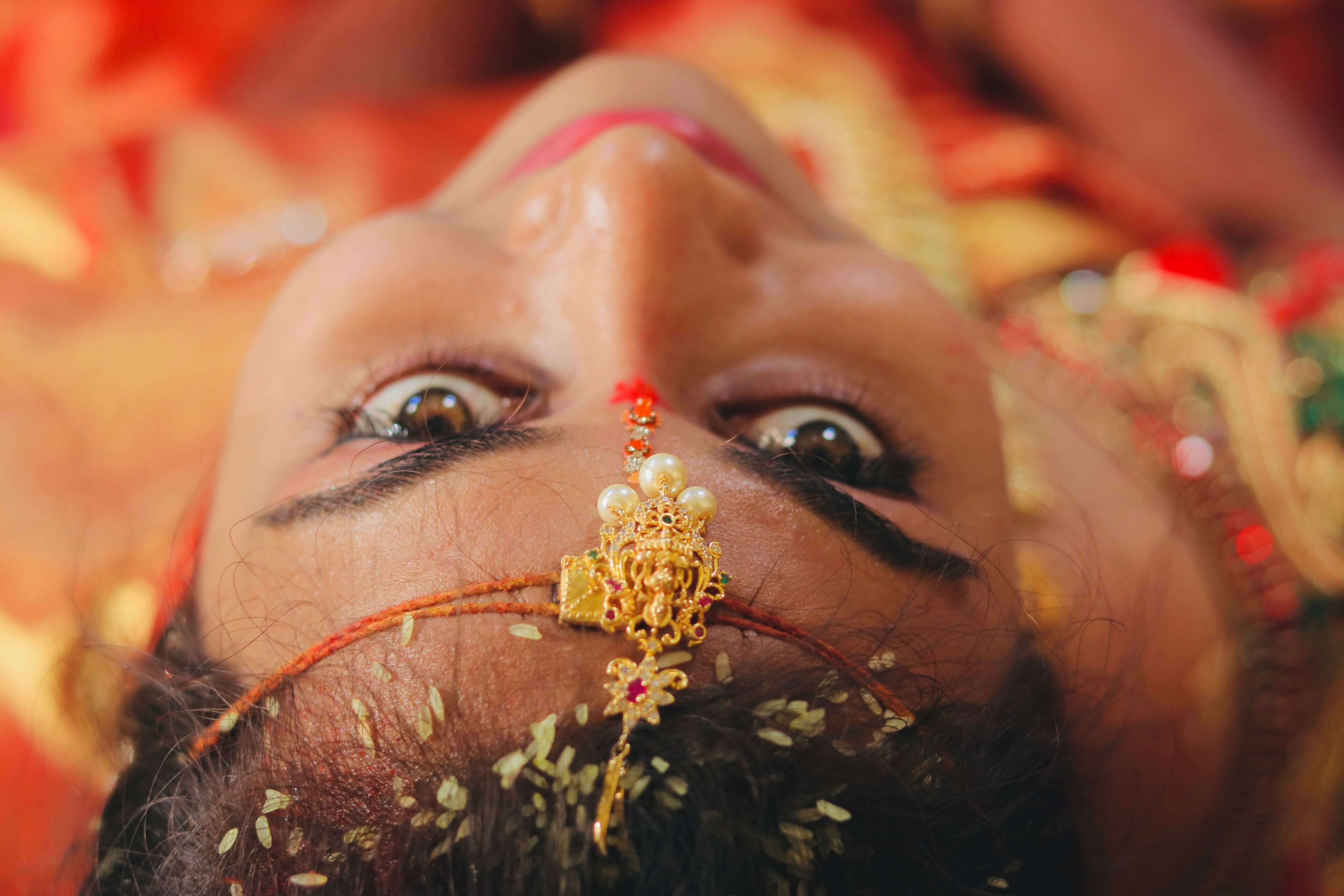 Close-up of a bride with intricate gold jewelry, capturing cultural elegance and beauty.