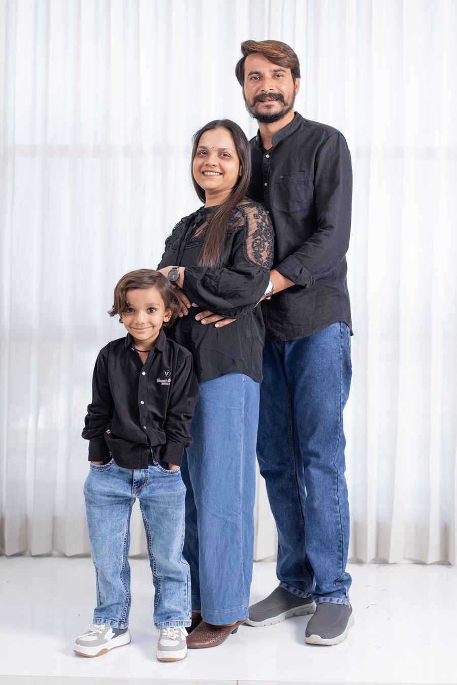 Illustrative smiling South Asian family with a young child