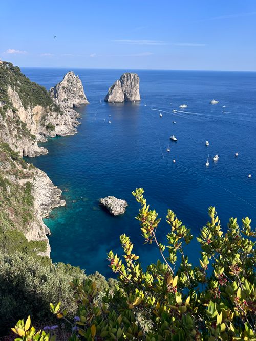 Free Captivating view of the Faraglioni rocks and crystal-clear sea near Capri, Italy. Stock Photo