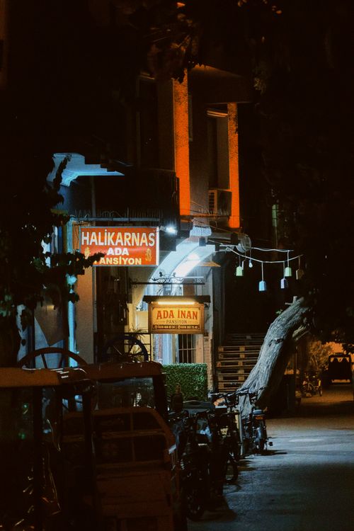 Free An atmospheric night scene of a charming street in Istanbul with glowing neon signs. Stock Photo