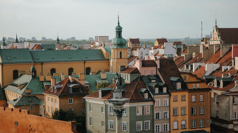 Charming panoramic view of Warsaw Old Town's colorful rooftops and classic architecture under a clear sky.