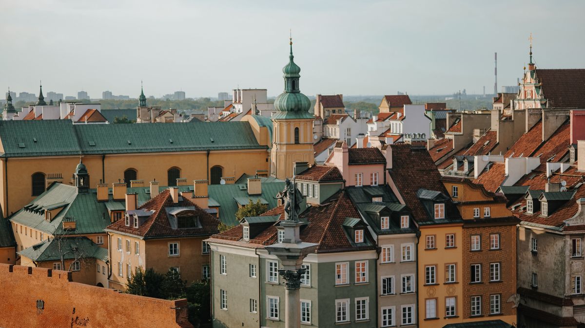 Charming panoramic view of Warsaw Old Town's colorful rooftops and classic architecture under a clear sky.