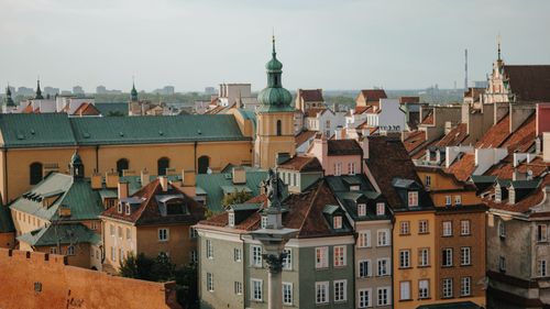 Free Charming panoramic view of Warsaw Old Town's colorful rooftops and classic architecture under a clear sky. Stock Photo